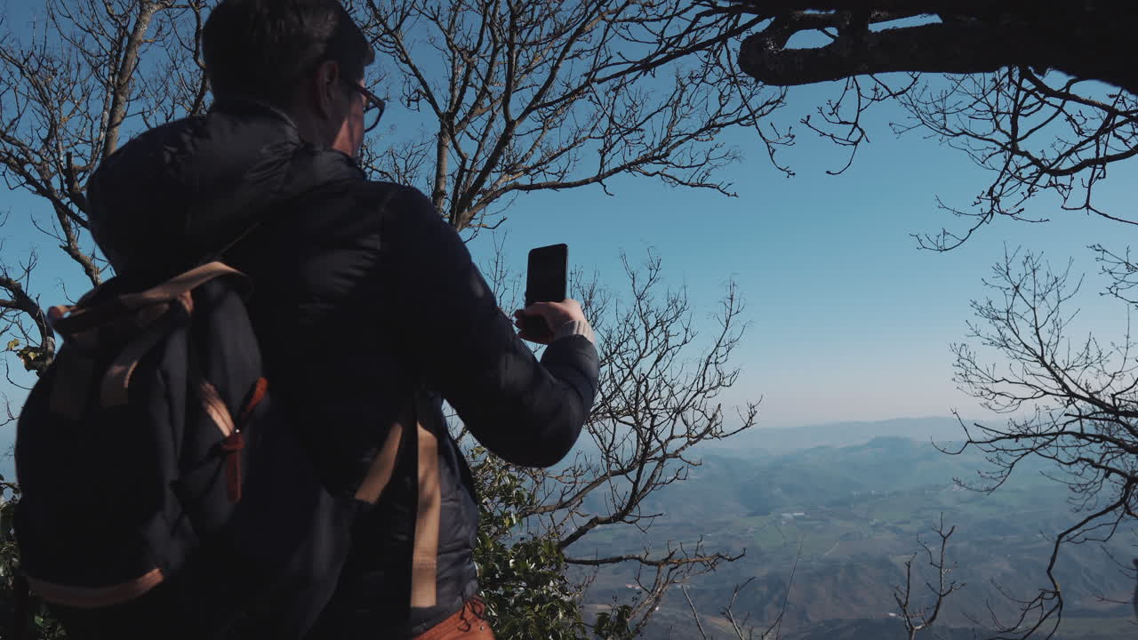 Woman Hiking and Taking Pictures of Mountain View