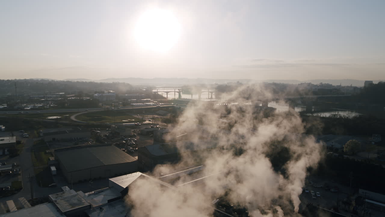 Aerial footage panning across the slowly rising steam coming off a factory on the north shore of Chattanooga, TN