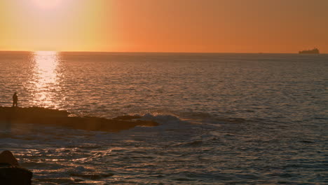 Human-silhouette-watching-sunrise-at-ocean.-Ferry-sailing-dawn-tranquil-water