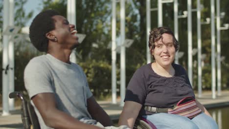 happy couple looking at each other and laughing in park