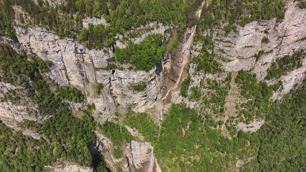 multi tiered seerenbachfälle waterfall flows down green alpine rock wall