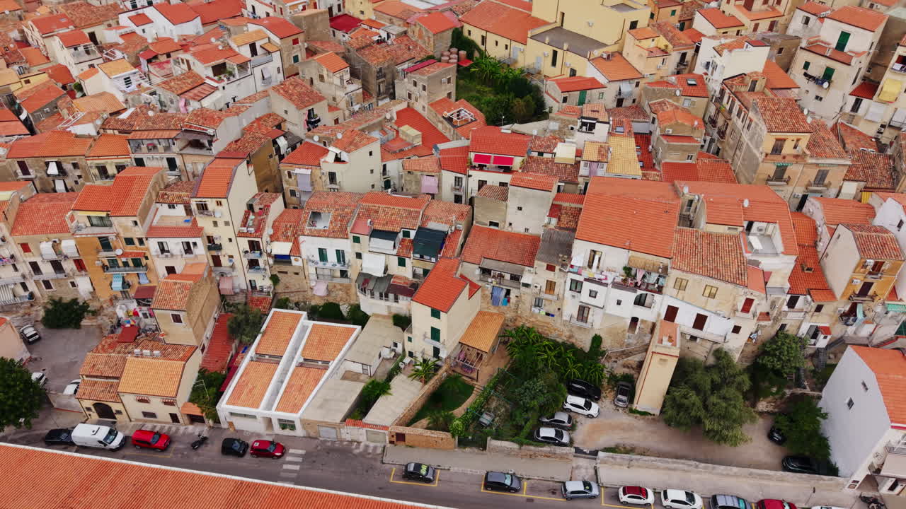 Aerial view of Cefalù, Sicily's historic coast with warm rooftops