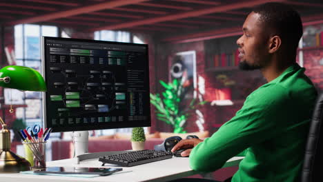 vertical video african american man looking at ui on pc screen at home office
