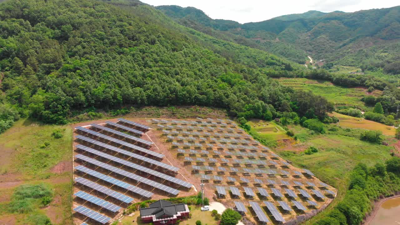 High altitude fly in towards solar power plant in the country side