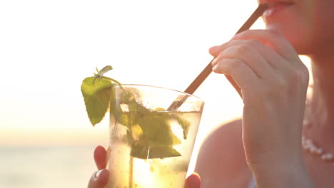 Woman-enjoying-a-mojito-cocktail