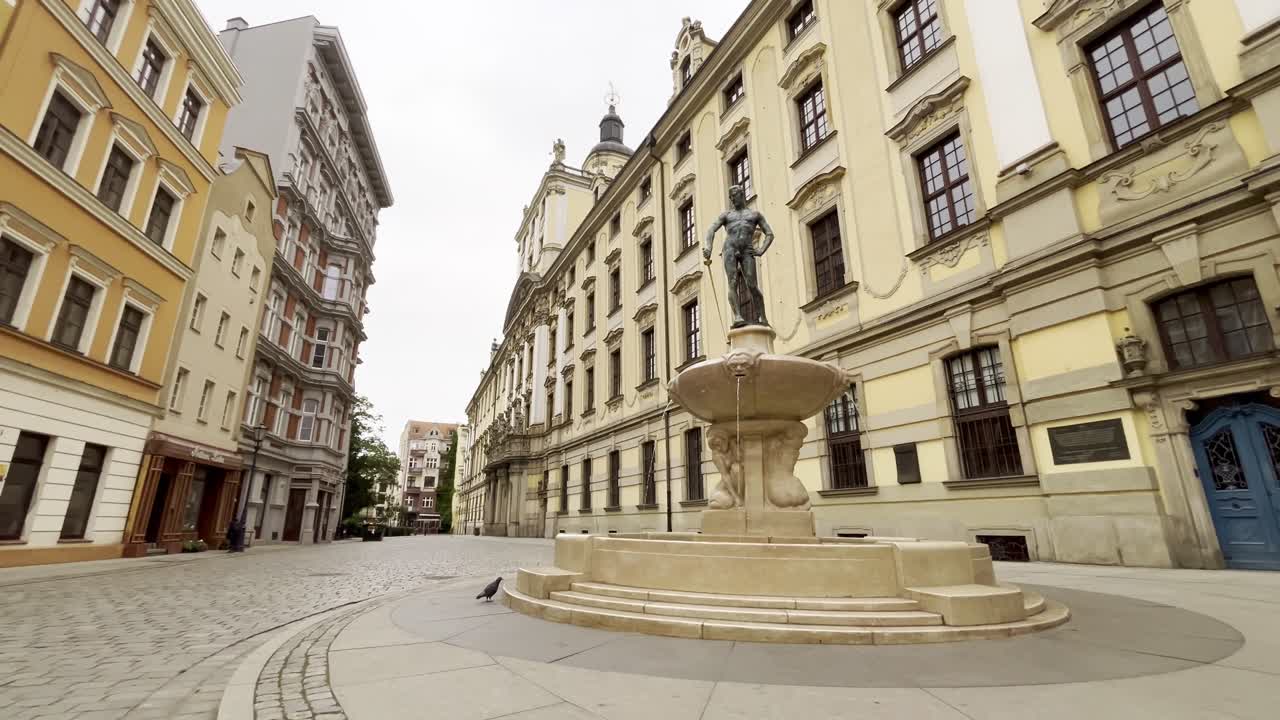 4K cinematic of Wroclaw University building and The Swordsman Fountain early morning with no people