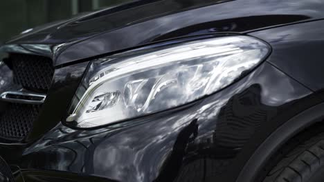 primer plano de las luces delanteras de un mercedes suv negro