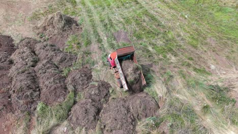 truck machine dumping soil at an active construction site with muddy terrain.