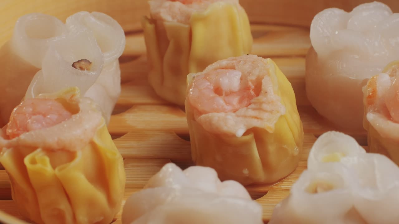 Various of dim sum on wooden steamer close-up macro. Steaming Technique. Chinese dessert food. Dimsum with shrimps, fish and meat. Dish in a cafe. Homade. Delivery