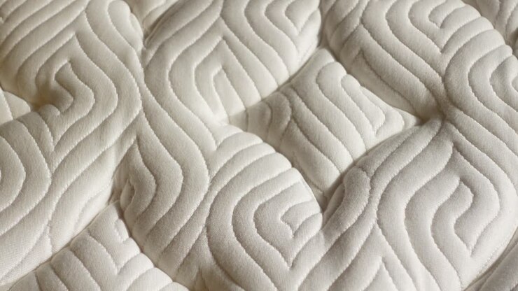 Close-up of a white quilted mattress topper