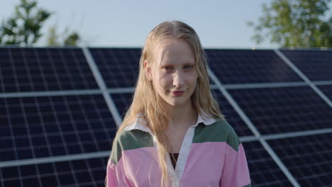 Portrait-of-a-teenage-girl-against-the-background-of-solar-panels-at-a-home-power-plant