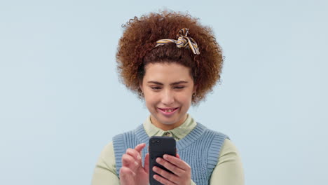 Phone,-smile-and-young-woman-in-studio-typing