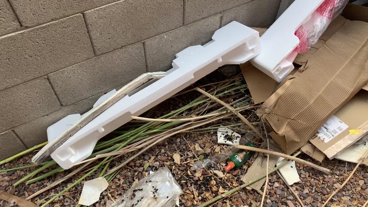 A top-down view of garbage in the back of a suburban home.