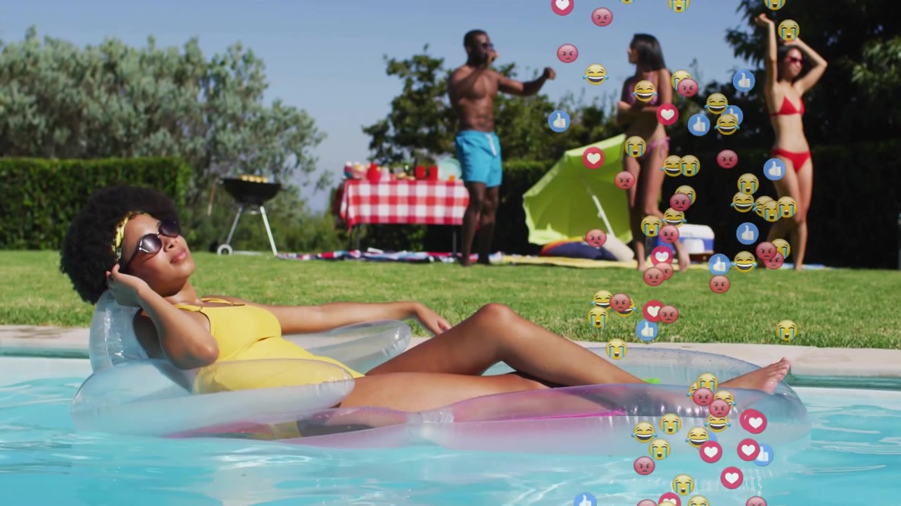Reclining woman floating on float, group filming and posing for sharing, reaction icons rising