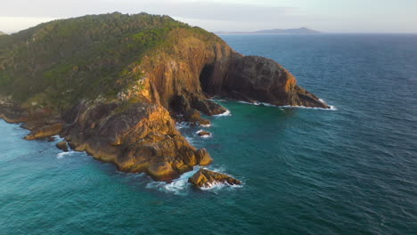 aerial shot of coastal headland cliffs at sunset