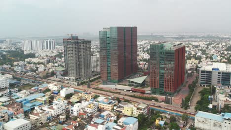 aerial shot of 3 it building in the middle of city india filled with small buildings