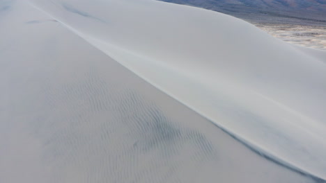 flying over a large sand dune on kelso dunes mojave national preserve