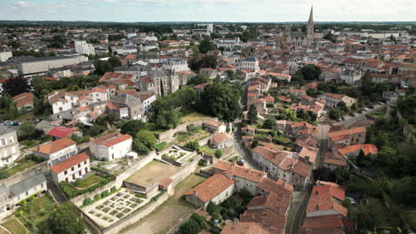 linear forward aerial view of an old french city with mix of modern and medieval buildings