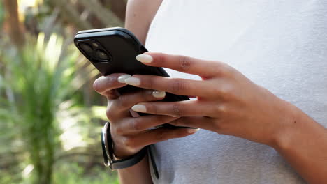 closeup of a woman on a phone typing a text