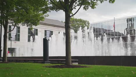 many fountains outside an office building on an overcast day in boston, massachusetts