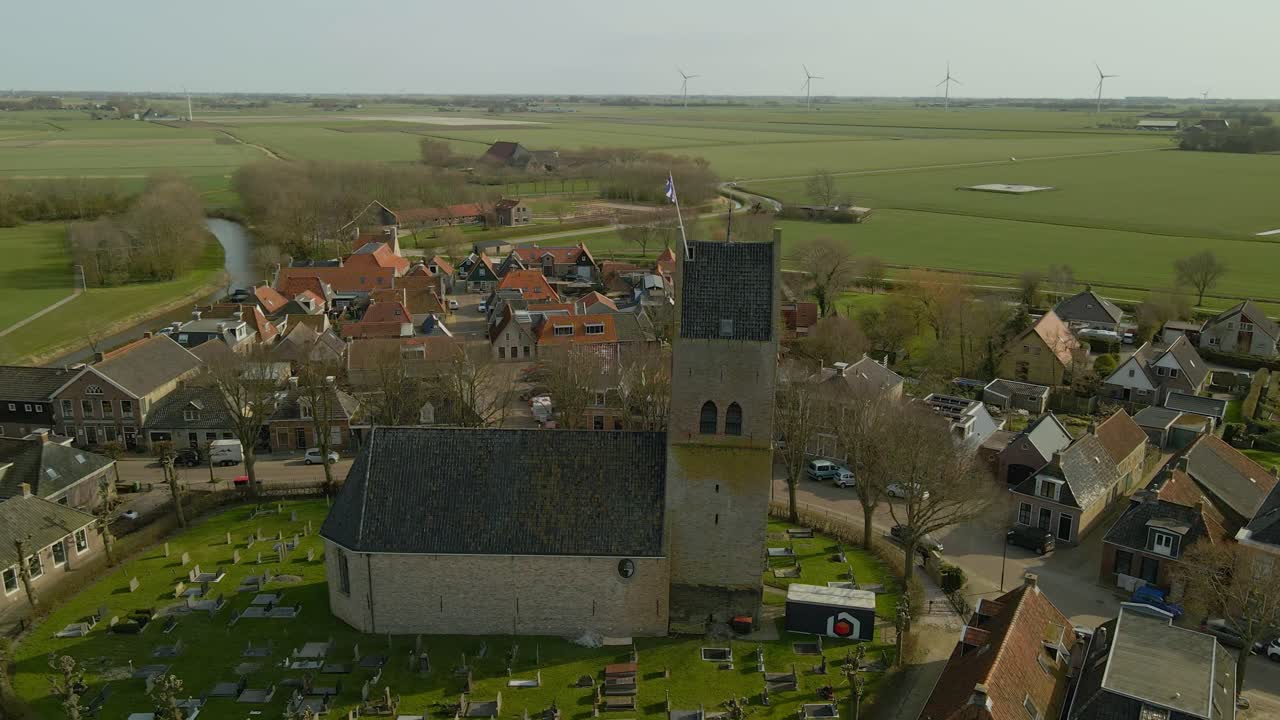 Luftfoto af charmerende landsby med kirkegård og marker, Pingjum, Friesland