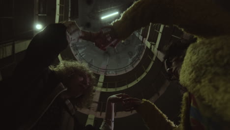 girls holding hands in abandoned building