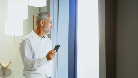 Businessman-using-mobile-phone-in-hotel-room-4k