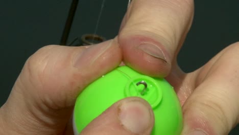 attaching a bobber to the fishing line - close up