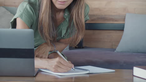 smart woman writing in notebook