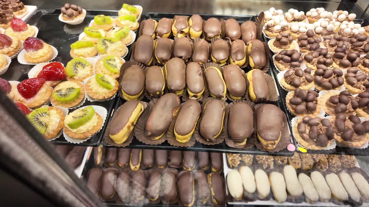 Colorful Display of Fresh Pastries, Eclairs, and Fruit Tarts