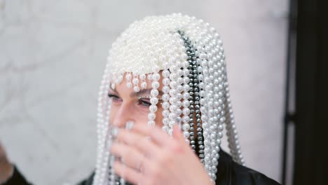 smiling woman wearing an ornate pearl beaded headpiece
