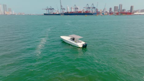 aerial drone shot of a boat going to the city in the ocean, colombia, cartagena