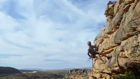 Mountaineer-rappelling-down-the-hill-with-the-help-of-rope-4k