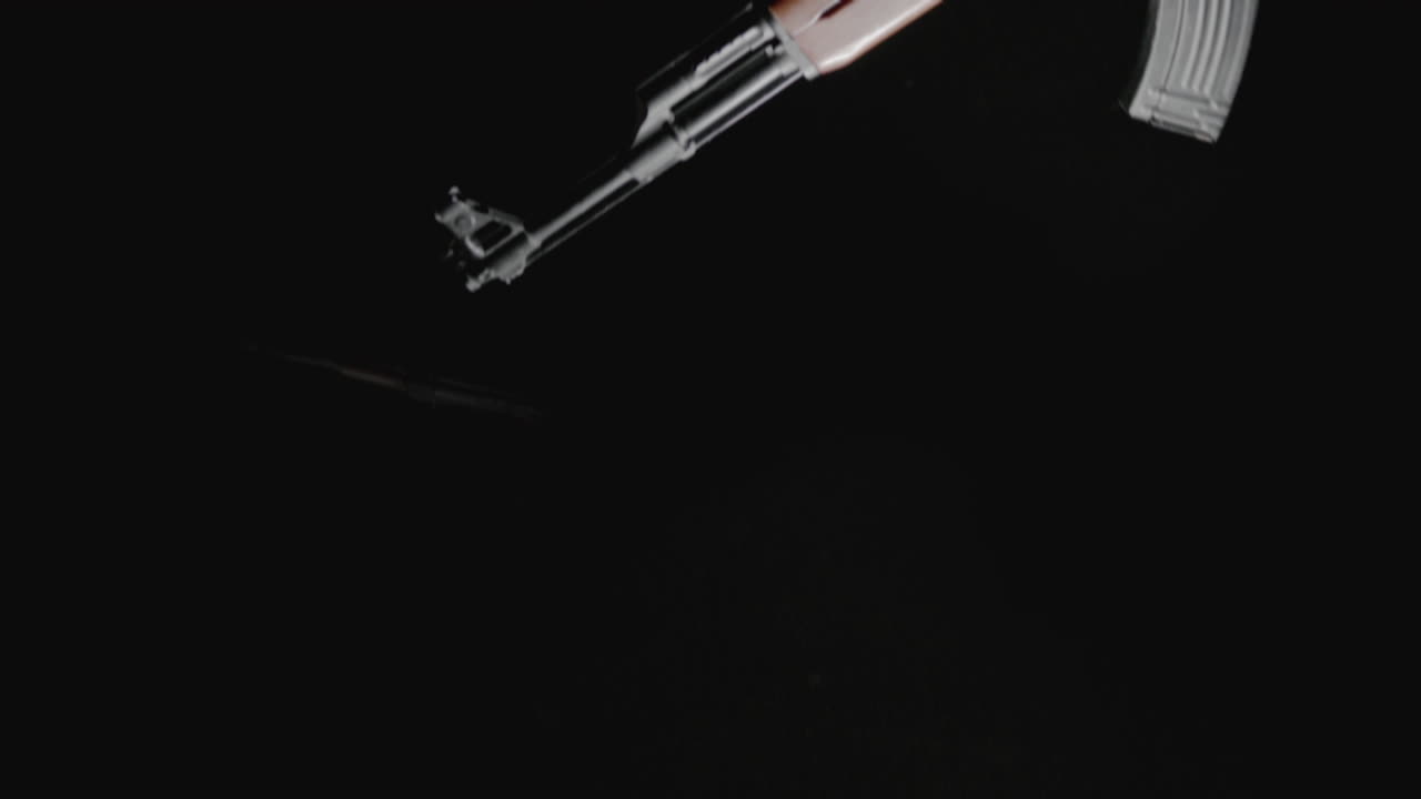 Machineguns on the dark background are falling in slowmotion