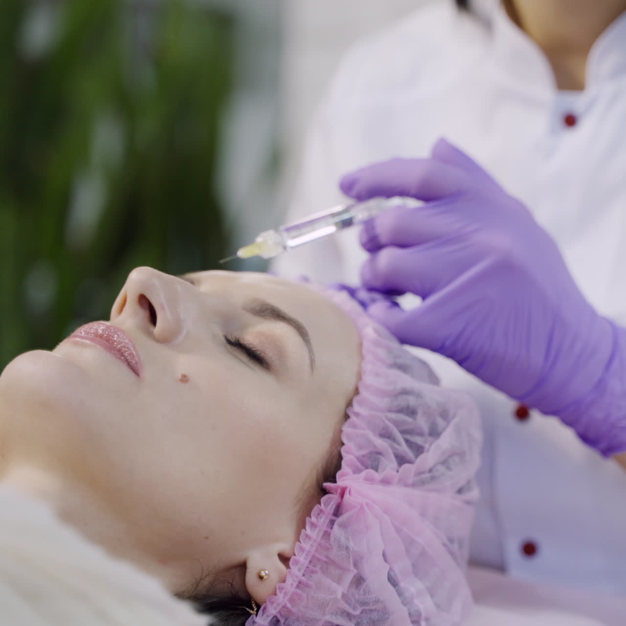 Hands of cosmetologist making injection in face. Aesthetic cosmetology.