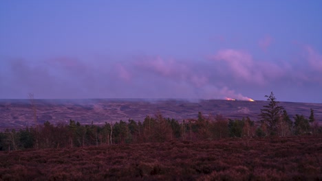 A-timelapse-of-heather-burning-in-the-North-York-Moors-National-Park,-England-at-dusk