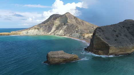 stunning aerial view of a caribbean coast with a rocky mountain and an impressive cliff, beautiful blue sky and sea