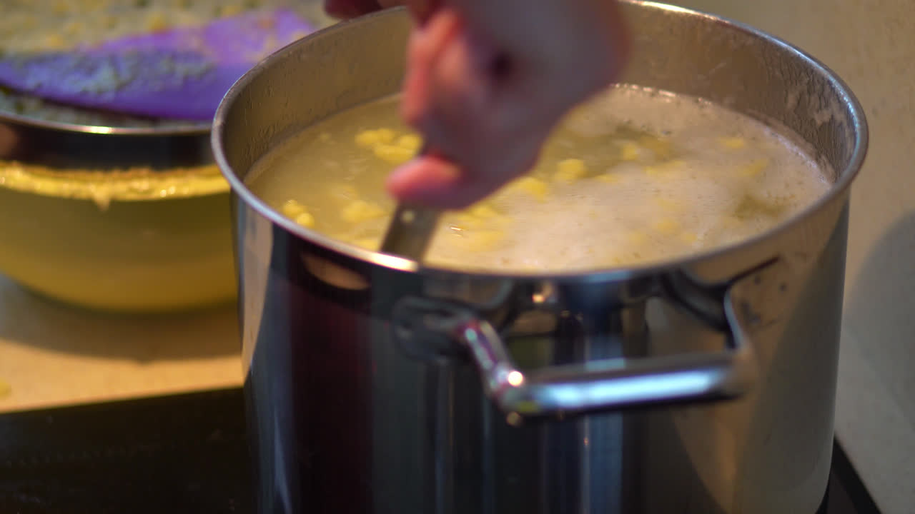 Cooking Potato Dough Lumps In A Pot With Boiling Water. Bryndzove Halusky Recipe. close up