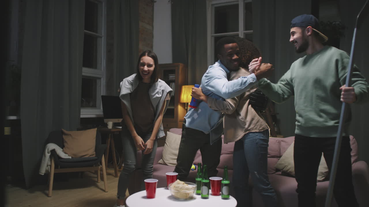 Friends Cheering While Watching Hockey Match On TV