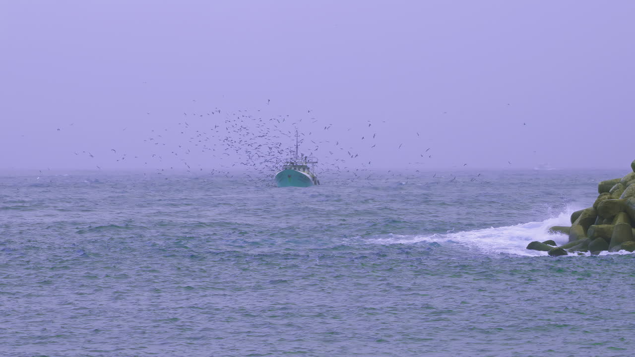 Fishing boat trawler sailing a rough Atlantic Sea in slow motion