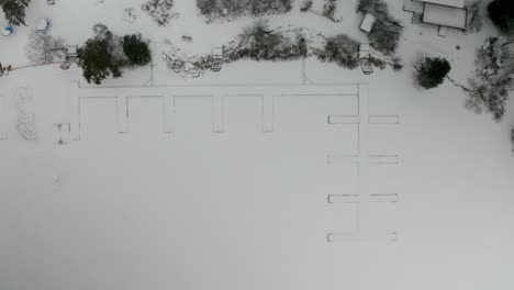 aerial ascent over snow covered docks frozen in the ice