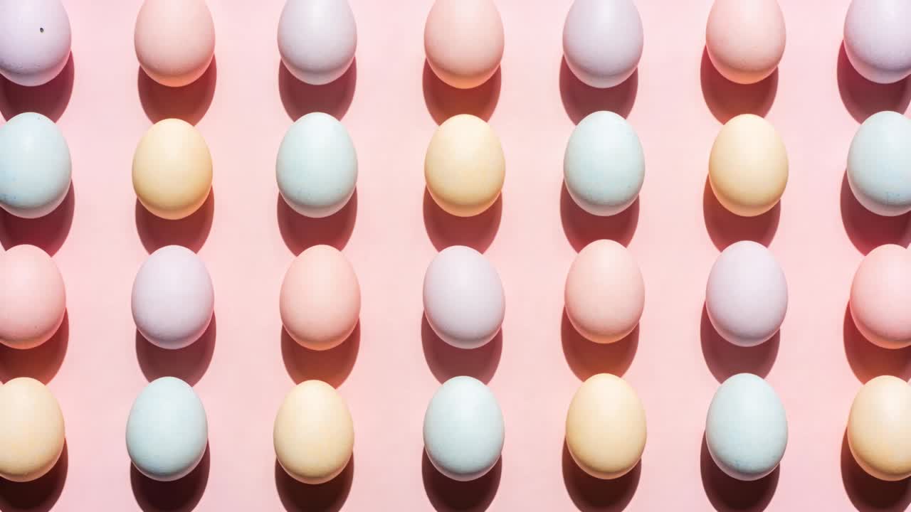 Pulling back camera revealing more pastel eggs on pink surface, to show grid pattern and shadows