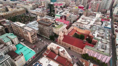 Drone-shot-of-the-Santo-Domingo-Church-and-the-contrasting-architecture-and-symmetrical-street-and-planning-of-downtown-Santiago-Chile
