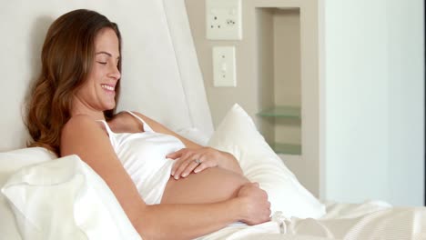 Pregnant-woman-relaxing-on-bed