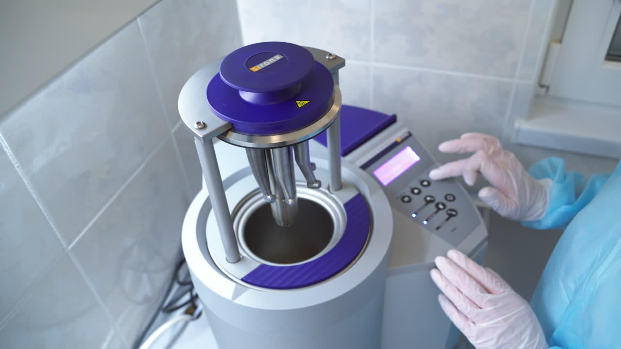 Advanced equipment for dental care hospital. Hands in white latex gloves press the buttons on the machine. Close up.