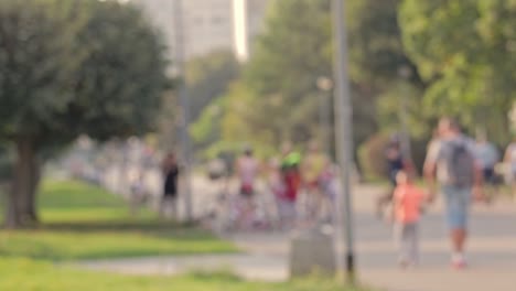 Regular-weekend-sunny-day-on-a-city-boulevard-crowded-with-people-and-families-walking-about