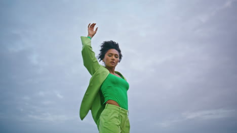 Woman-dancing-evening-sky-stormy-weather.-Girl-performing-modern-choreography.