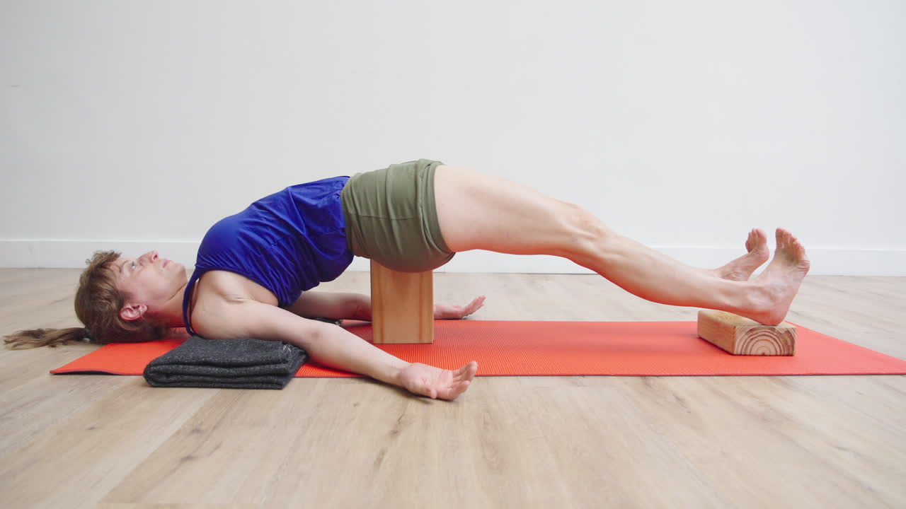 Woman Relaxing in Supported Bridge Yoga Pose