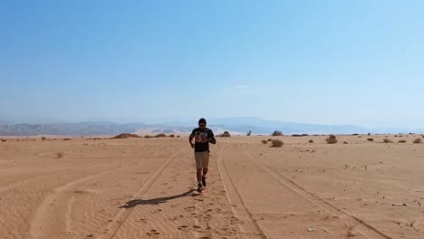 man running through wadi musa desert