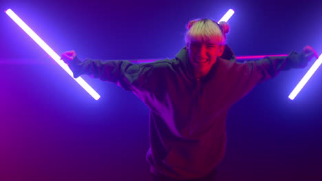 woman dancing freestyle hip hop in neon lights. blonde jumping in ultraviolet.